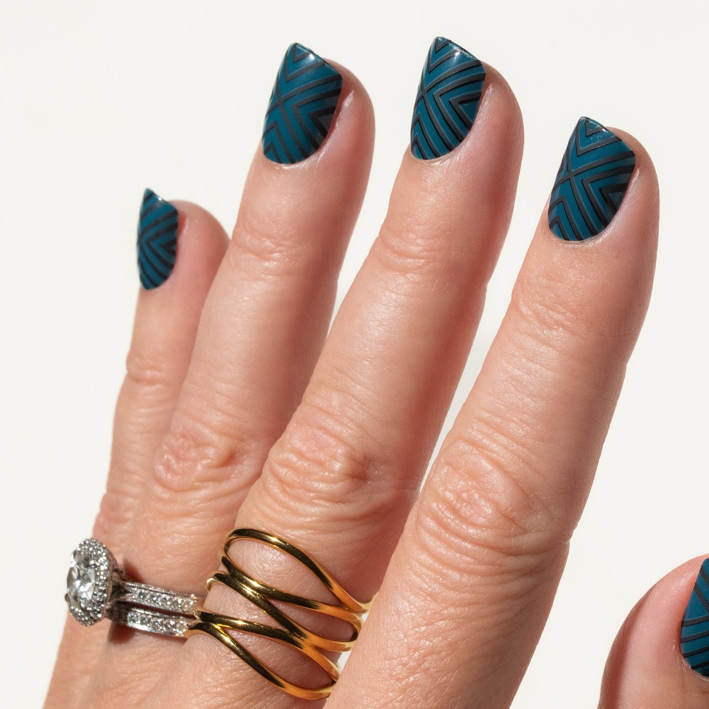 Hand with blue press on nails on a white background