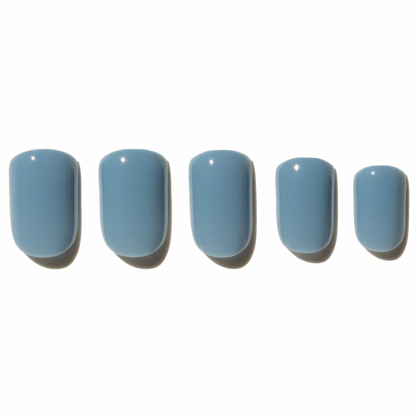 Five blue press on nails on a white background