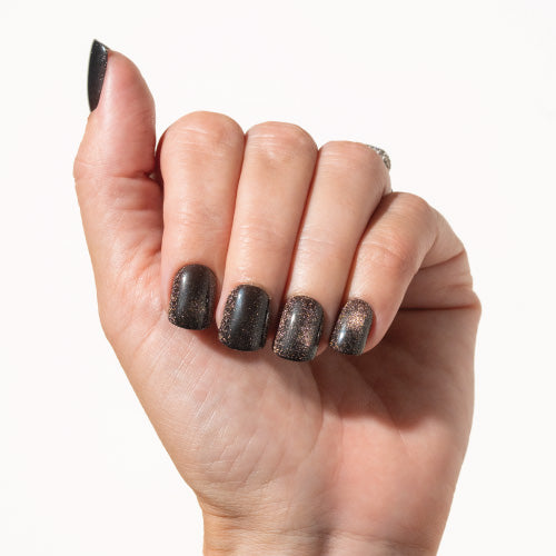 Hand with dark press on nails on a white background