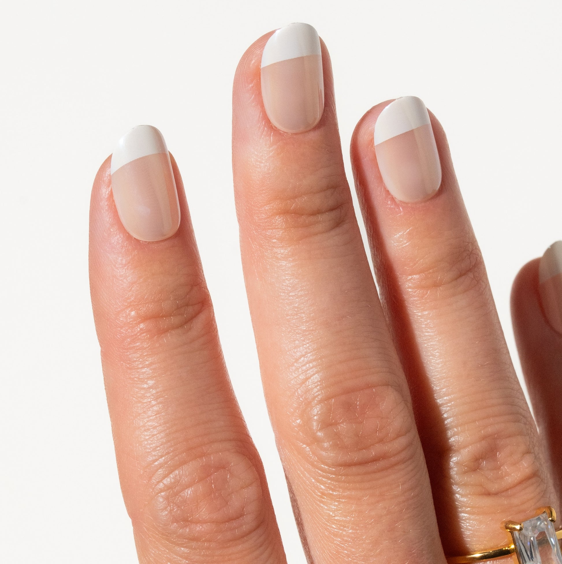 Close-up of a hand french tip press on nails on a white background