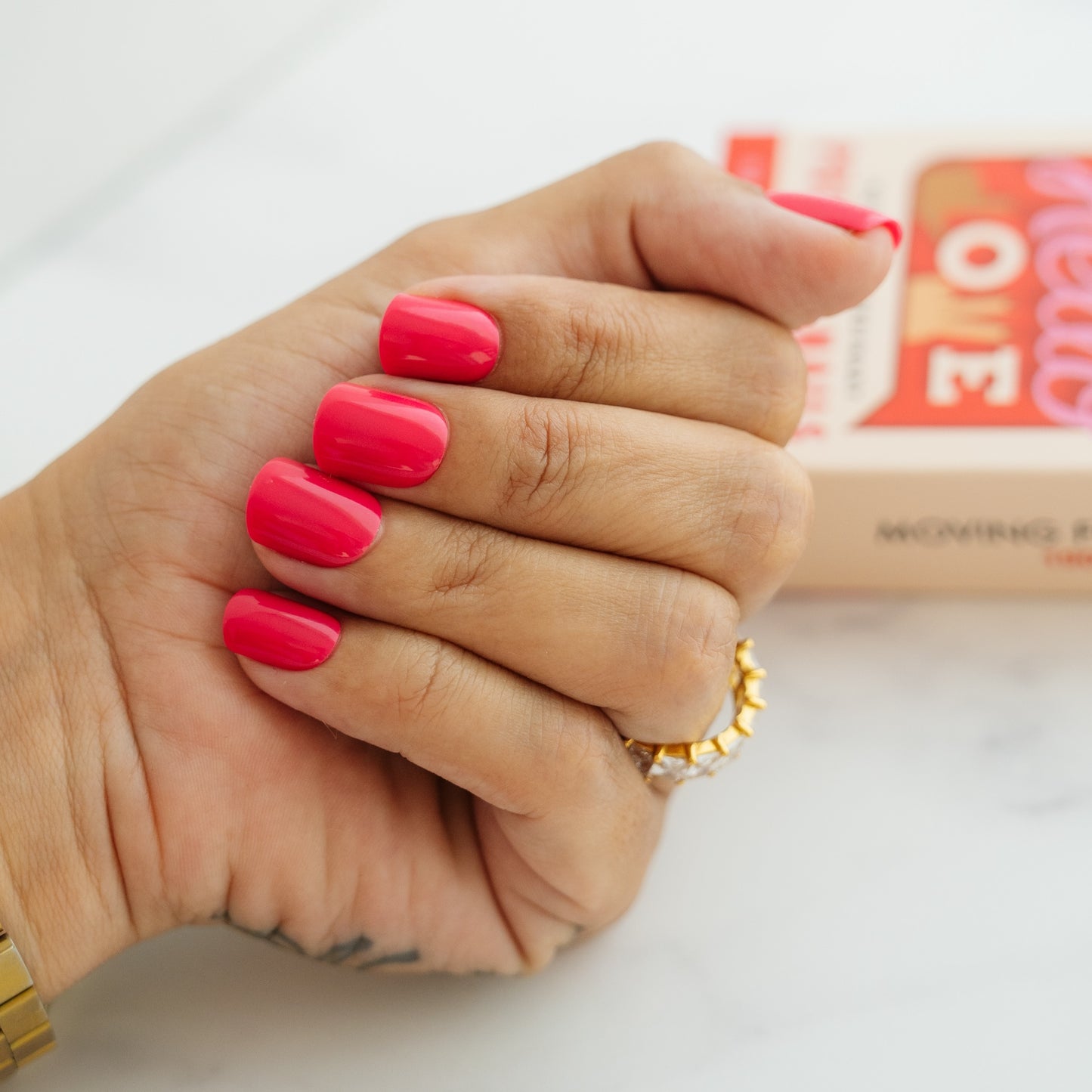 Hand with pink press on nails