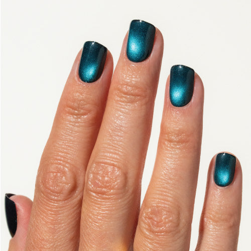 Hand with teal press on nails on a white background