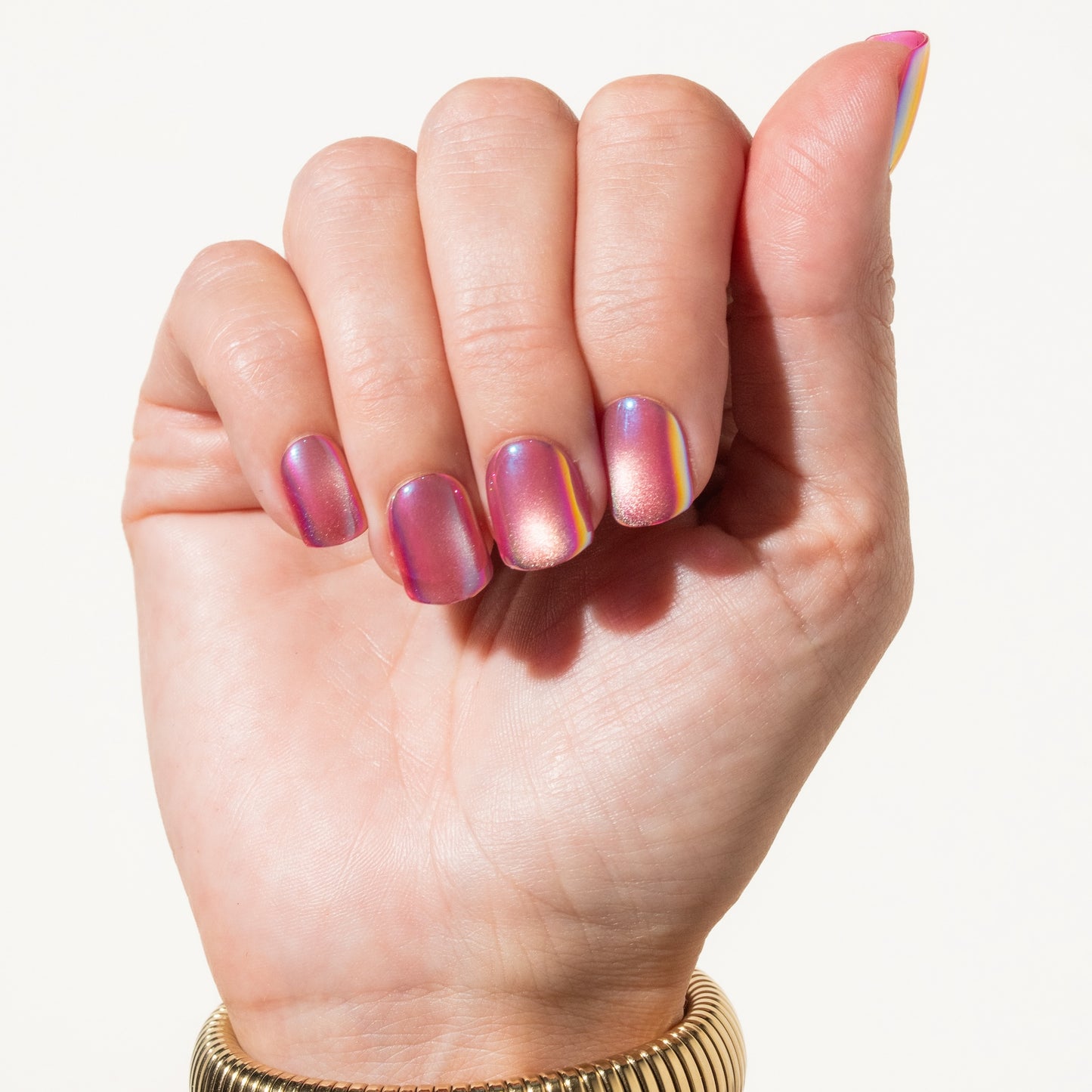 Hand with pink press on nails on a white background