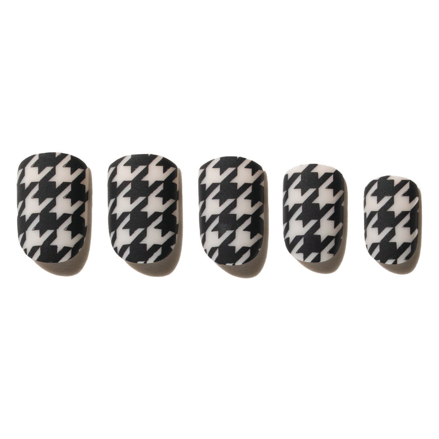 Set of five black and white houndstooth patterned press on nails on a white background