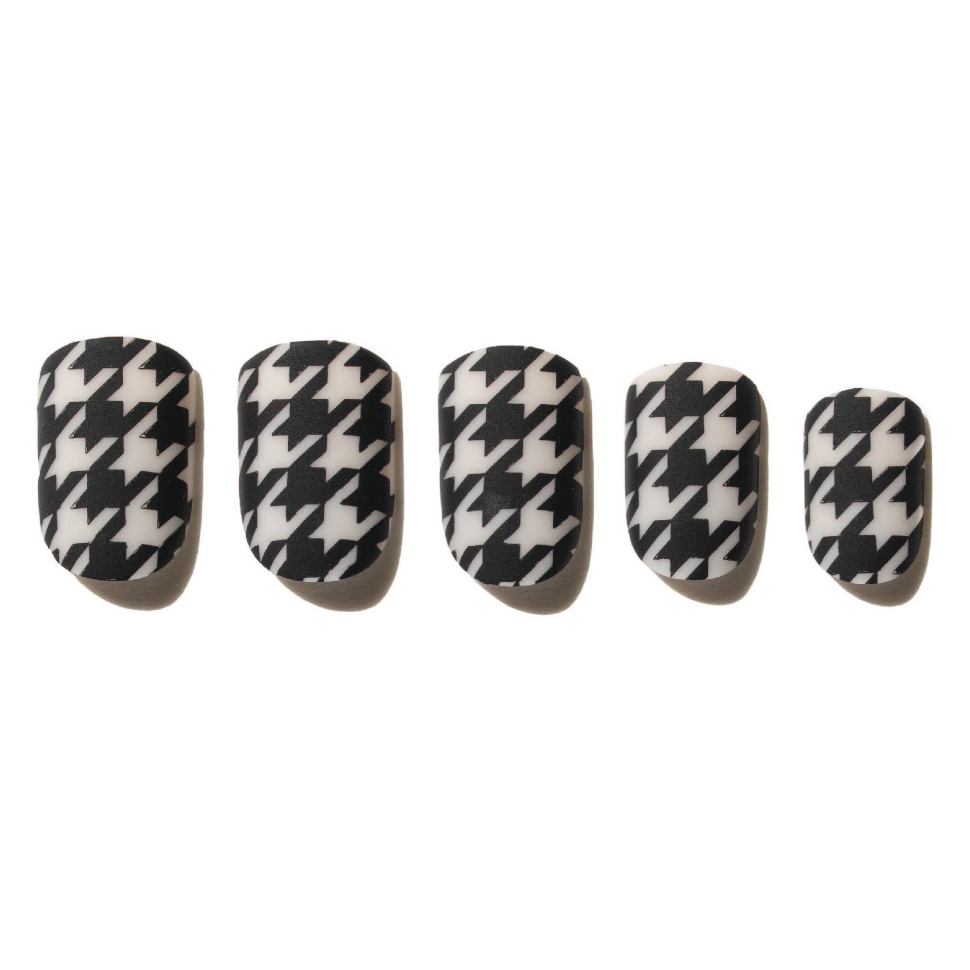 Set of five black and white houndstooth patterned press on nails on a white background