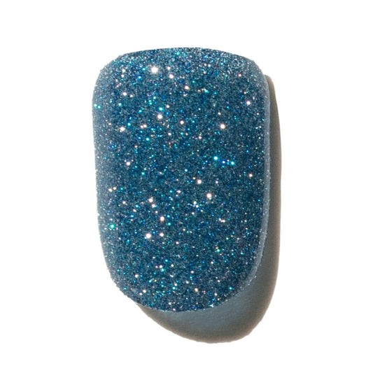 Blue glittery press on nail on a white background