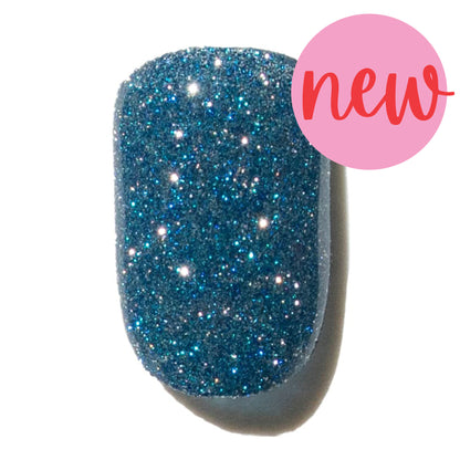 Blue glittery press on nail with a pink 'new' label on a white background