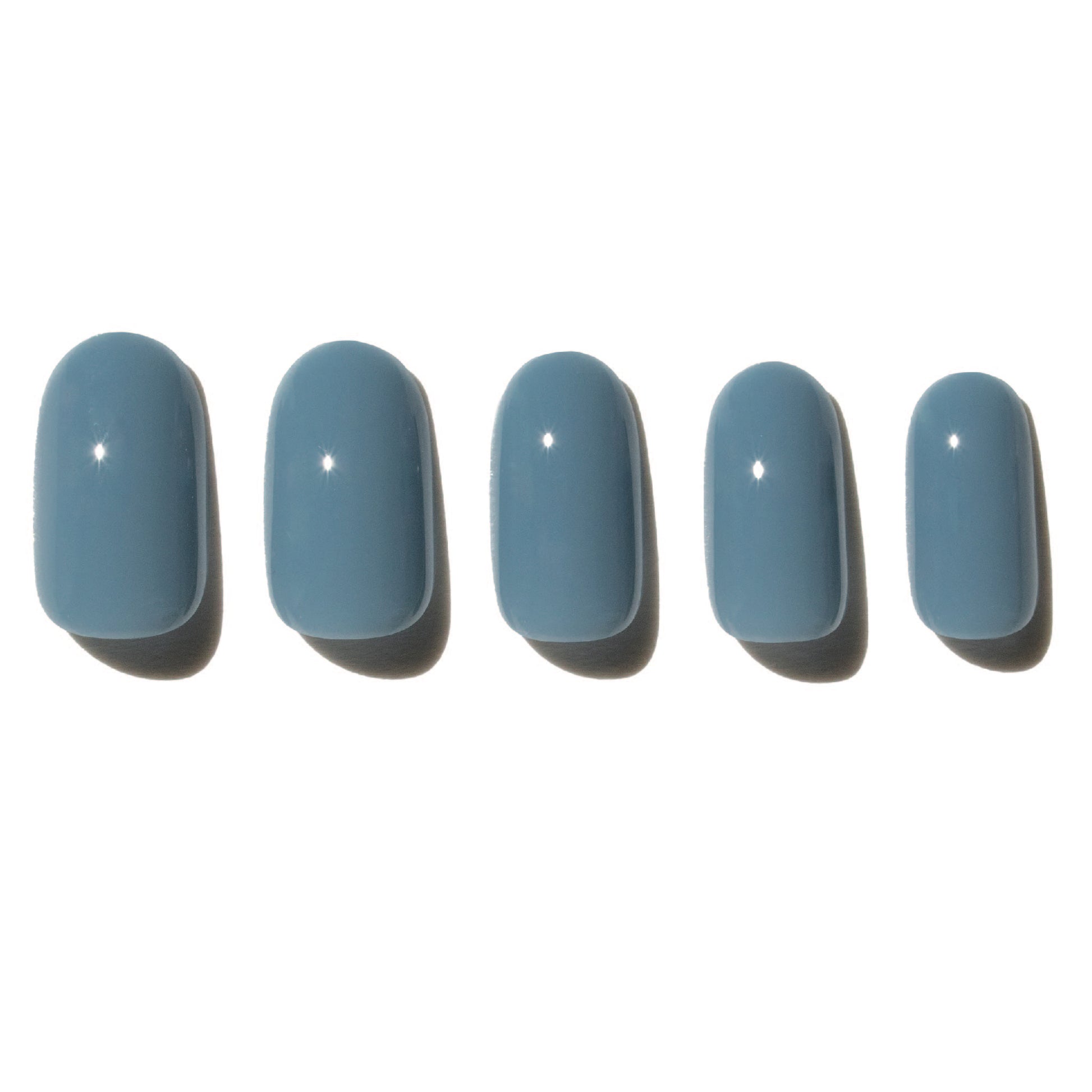 Five denim blue press on nails on a white background
