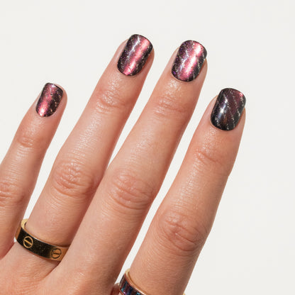 Close-up of a hand with press on nails on a light gray background