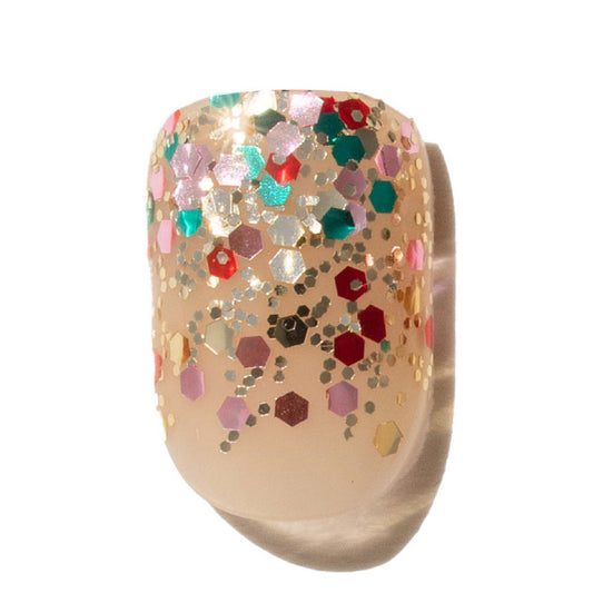 Christmas glitter press on nail. Mulit-colored glitter on nude press on nail.