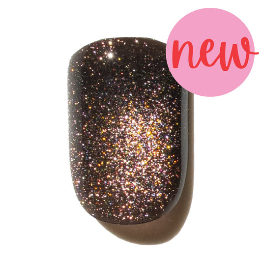 Glittery copper press on nail with a 'new' label on a white background