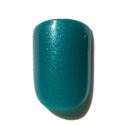 Teal press on nail on a white background