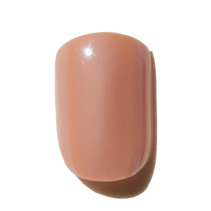 Nude-colored press on nail on a white background