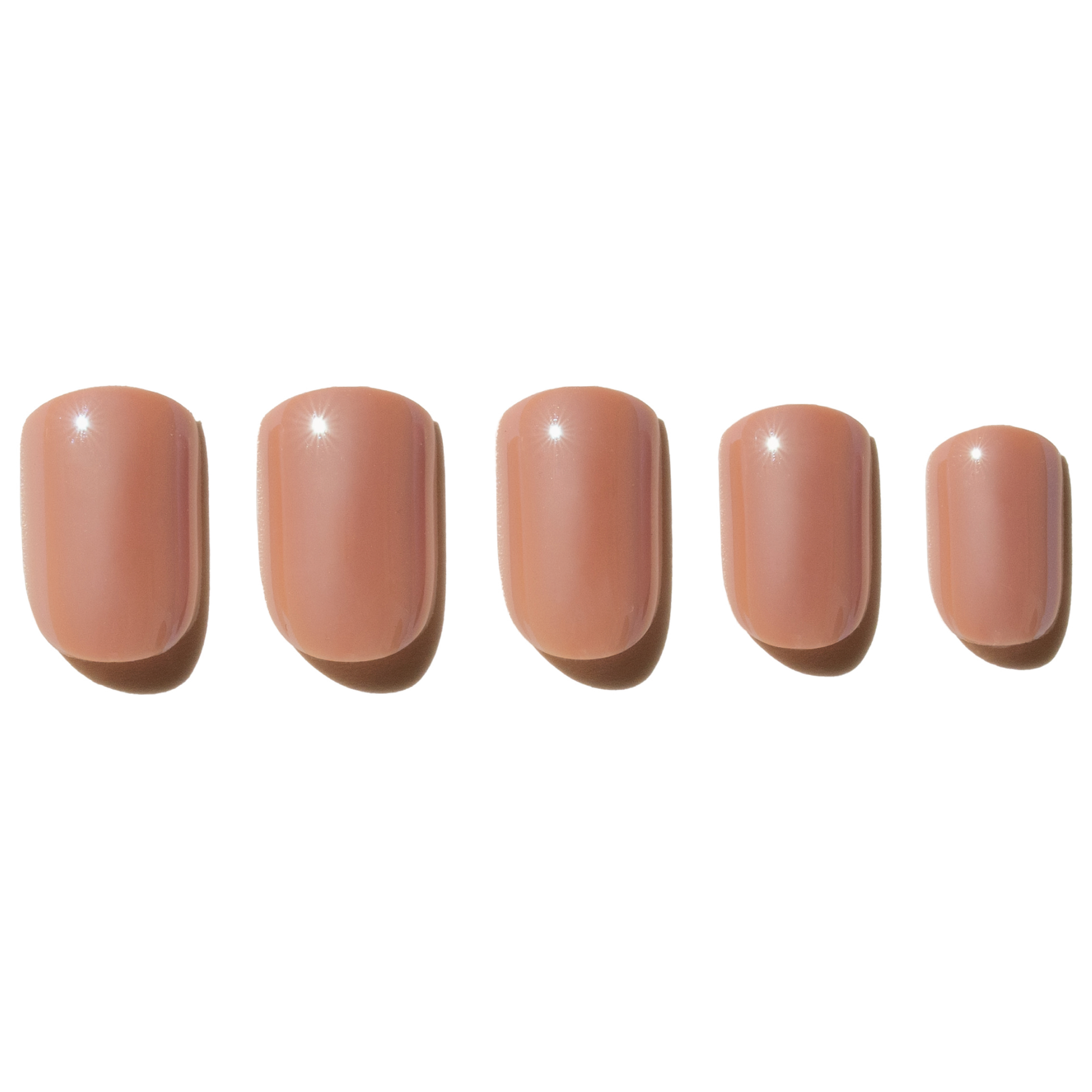 Five nude-colored press on nails on a white background