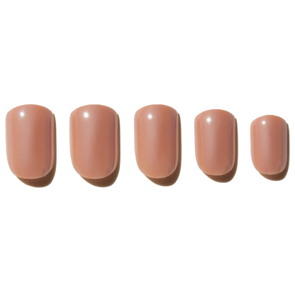 Five nude-colored press on nails on a white background