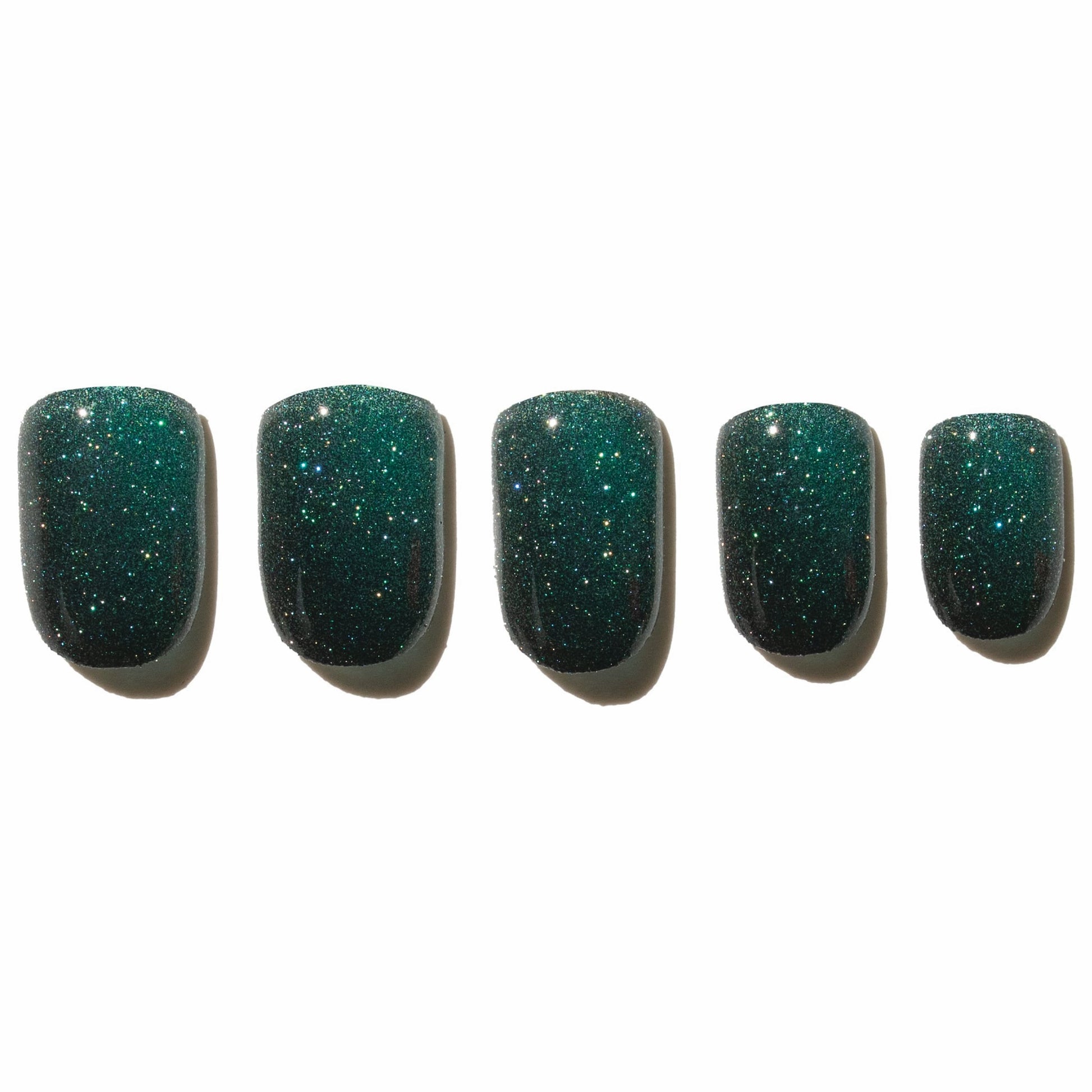 Five green glittery press on nails on a white background