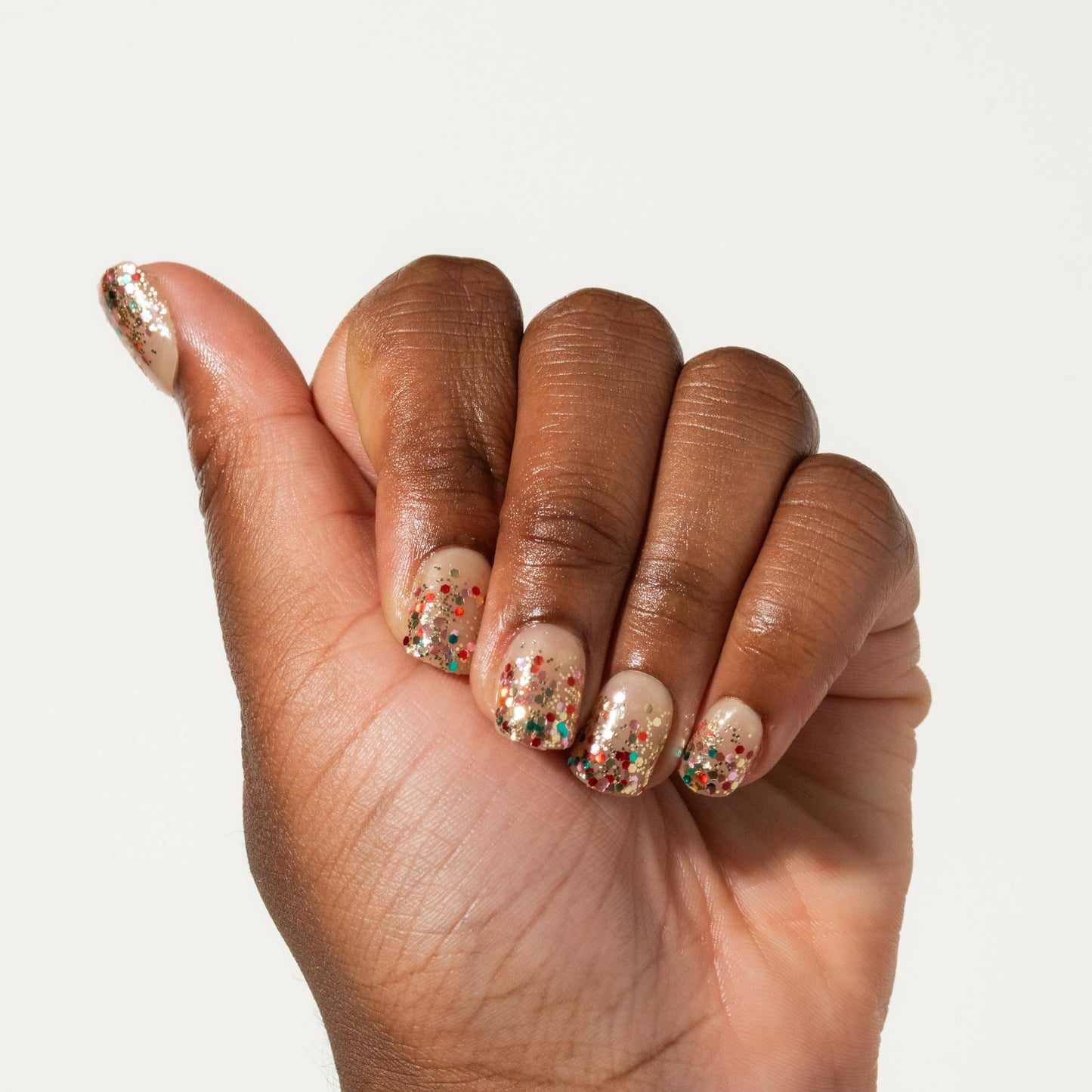 Hand with glitter nails on a white background