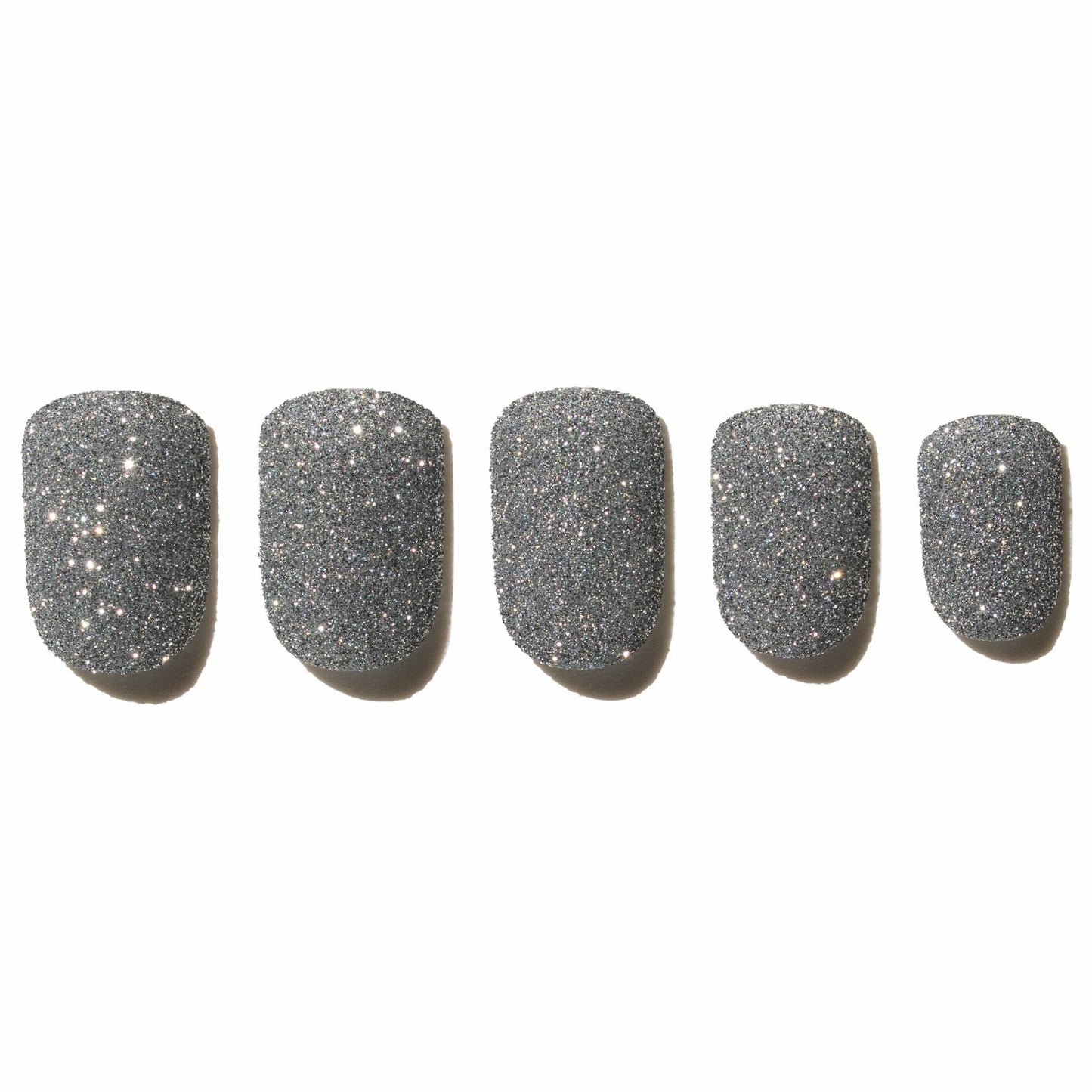 Five glittery silver press on nails on a white background