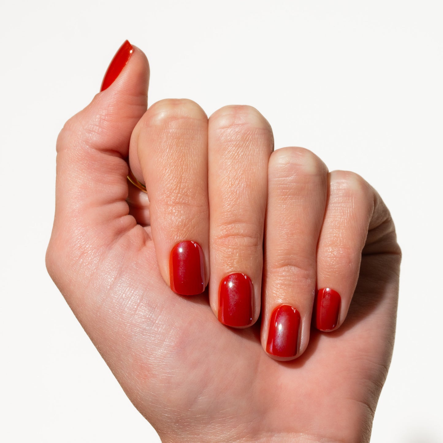 Hand with red press on nails on a white background
