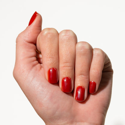 Hand with red press on nails on a white background