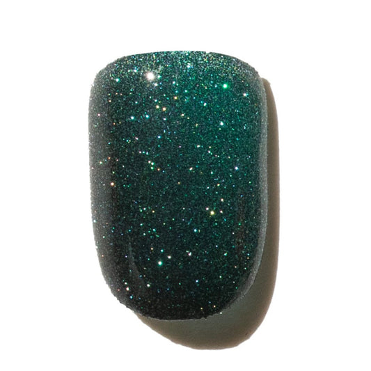 Press On Nail with glittery green finish on a white background