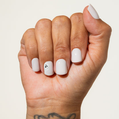 Hand with halloween press on nails oh on a plain background