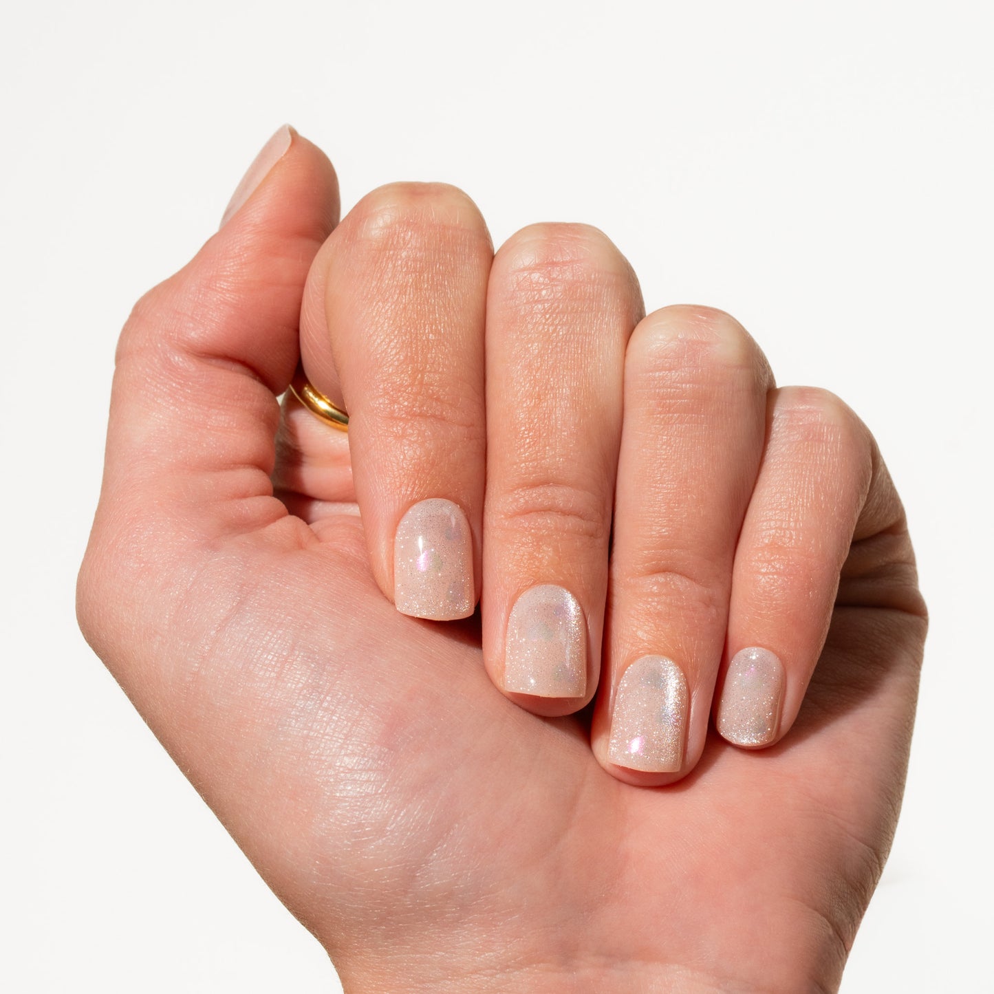 Hand with light pink press on nails on a white background