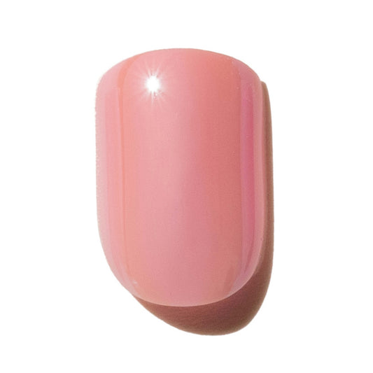 Single pink press on nail on a white background