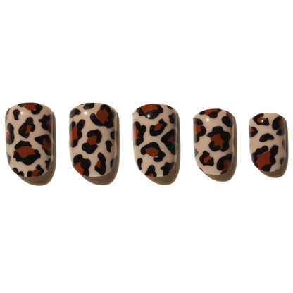 Five press on nails with leopard print design on a white background
