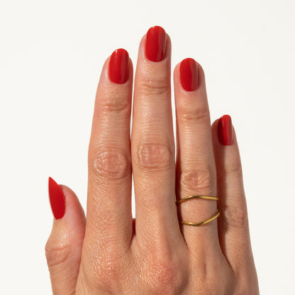 Hand with red press on nails on a white background