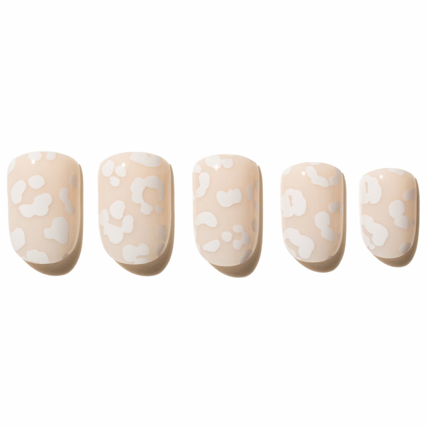 Five beige press on nails with white leopard print on a white background