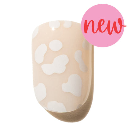 Press on nail with white leopard print on a beige background, labeled 'new'.