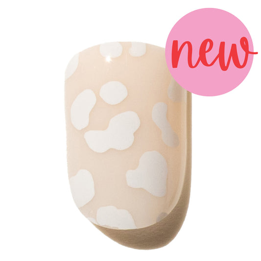 Press on nail with white leopard print on a beige background, labeled 'new'.