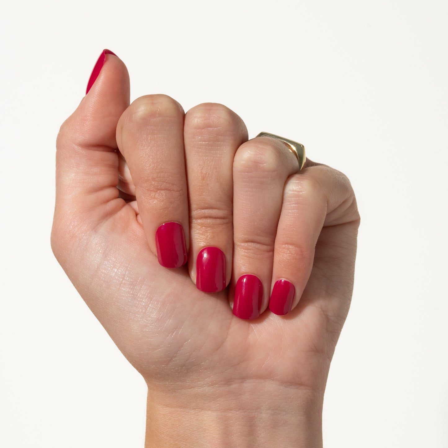 Hand with pink press ons on a white background