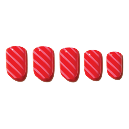 Set of red press on nails with pink diagonal stripes on a white background