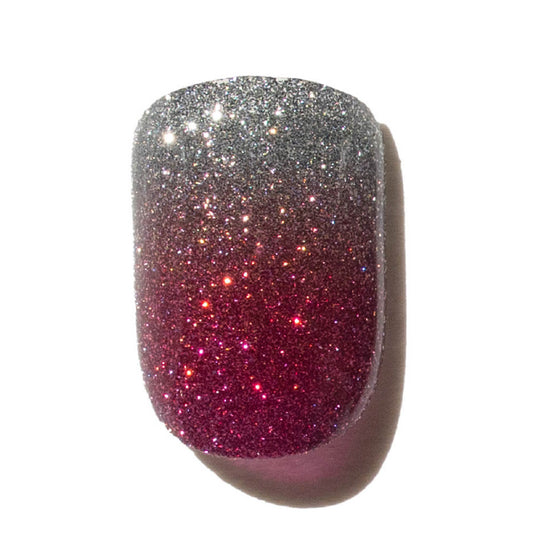 Press on nails with glittery silver and pink gradient on a white background