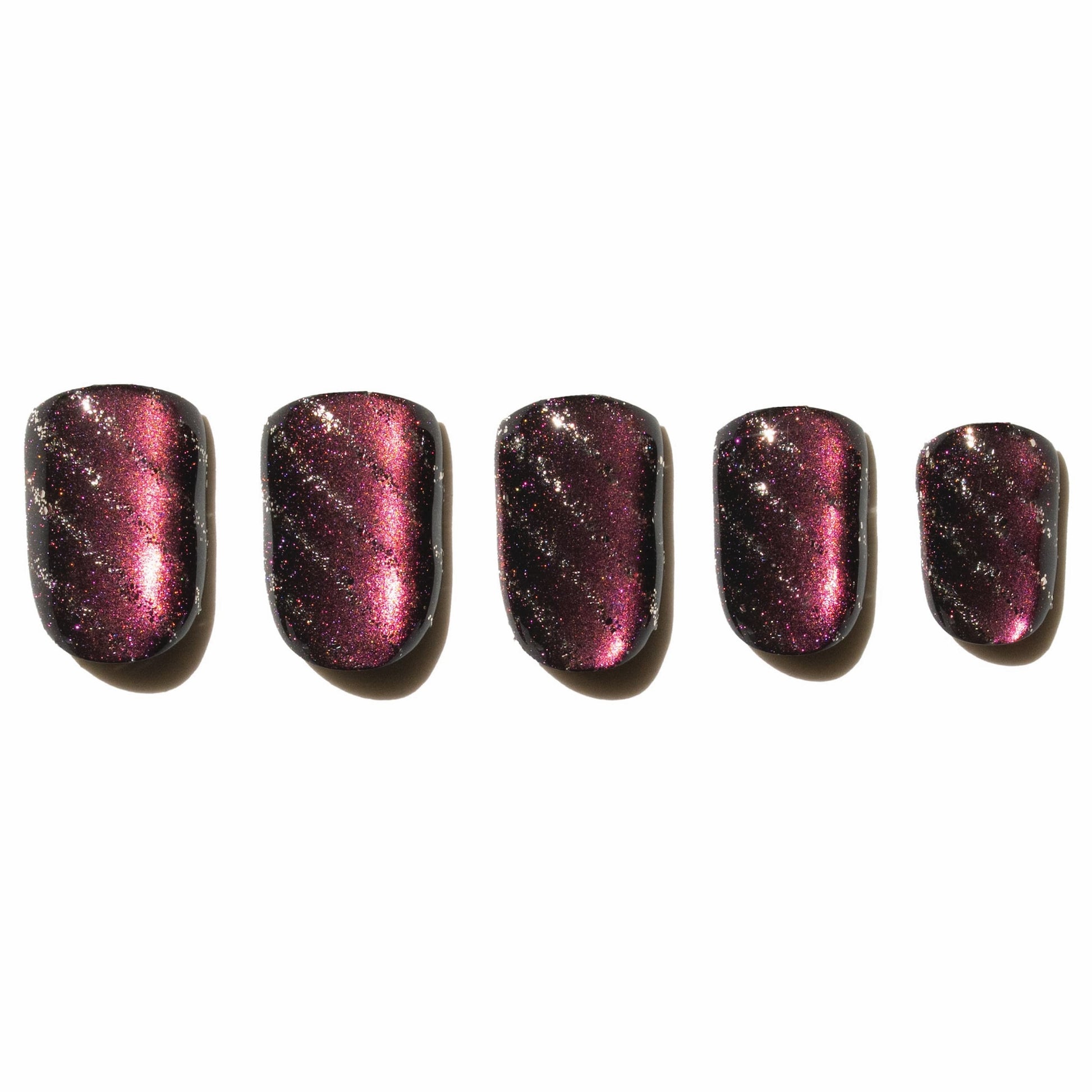 Five purple glittery press on nails on a white background