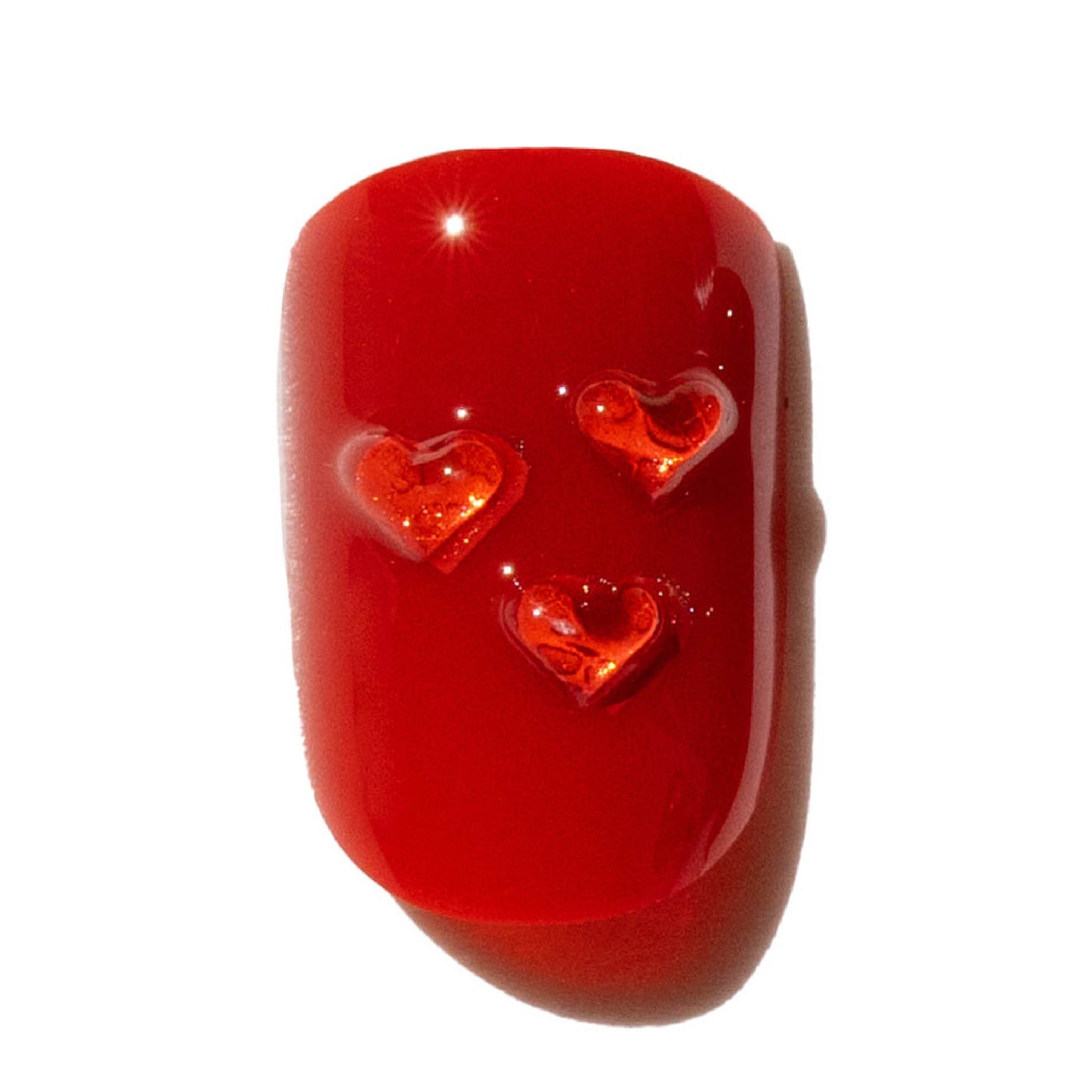 Red press on nail with heart designs on a white background