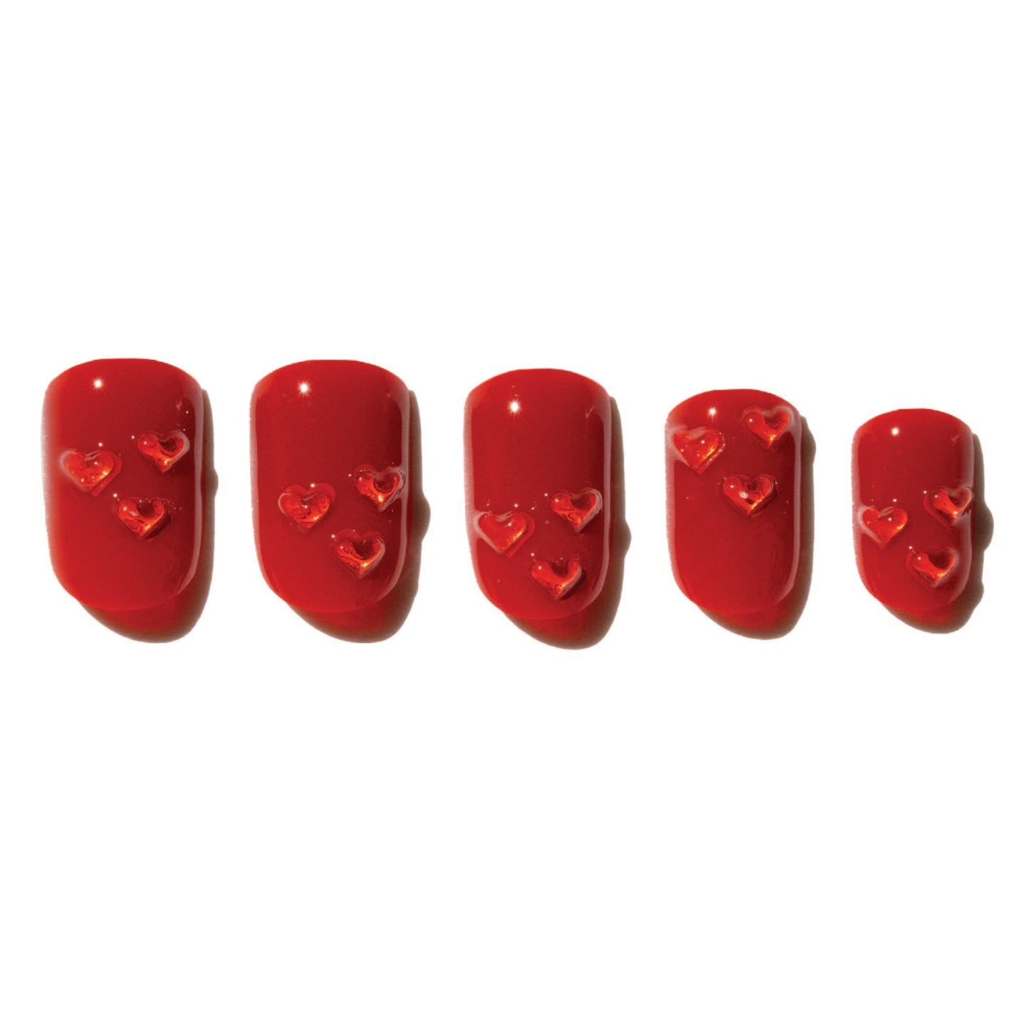 Set of red press on nails with heart designs on a white background 