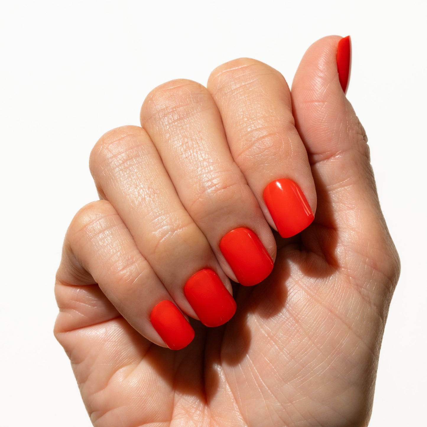 Hand with red press on nails on a white background