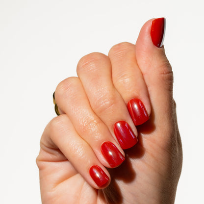 Hand with red press on nails on a white background