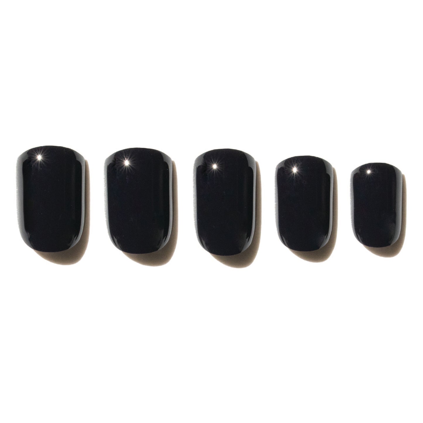 5 black press on nails on a white background