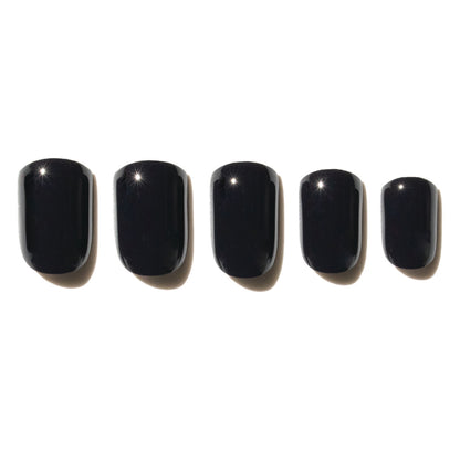 5 black press on nails on a white background