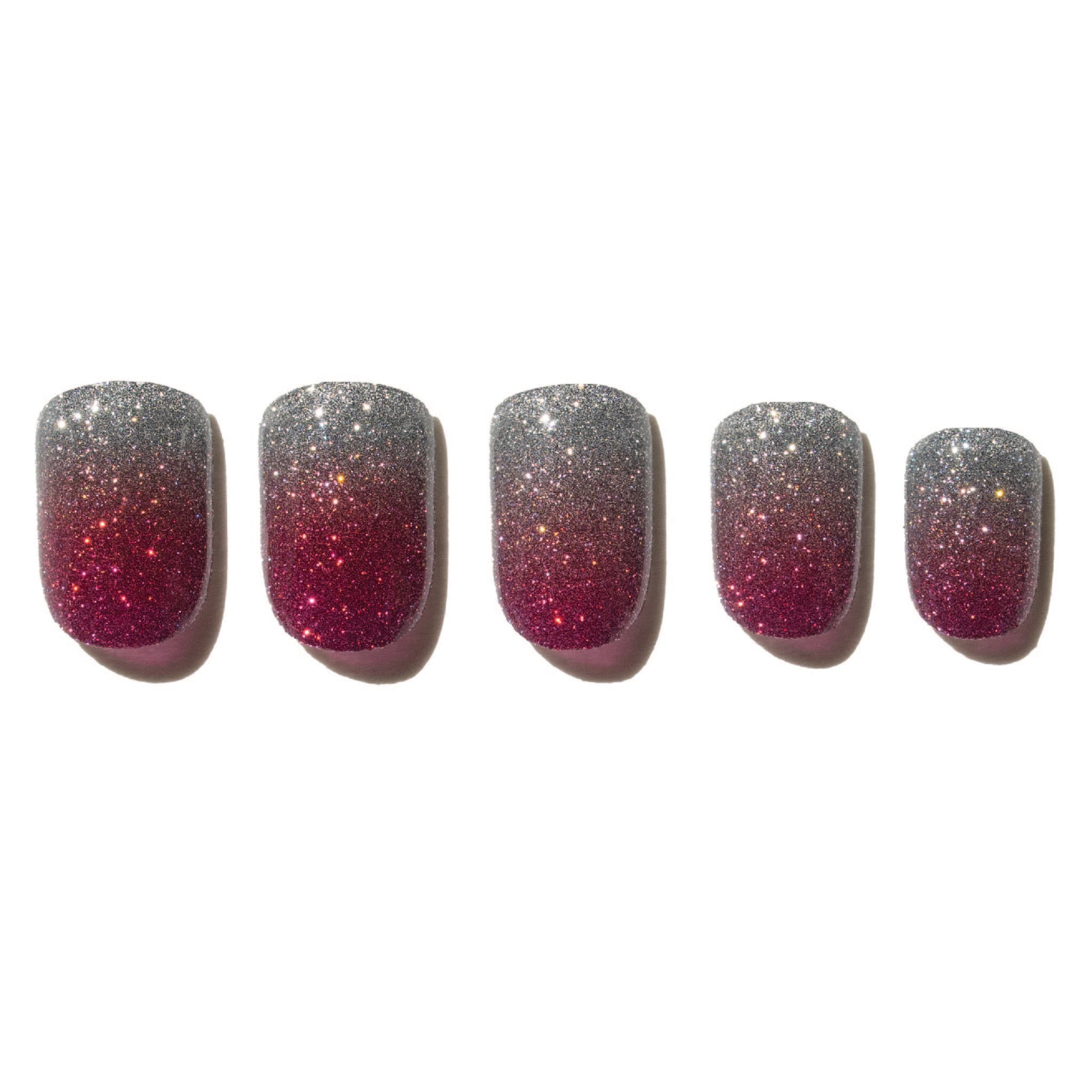 Five glittery pink and silver nails on a white background