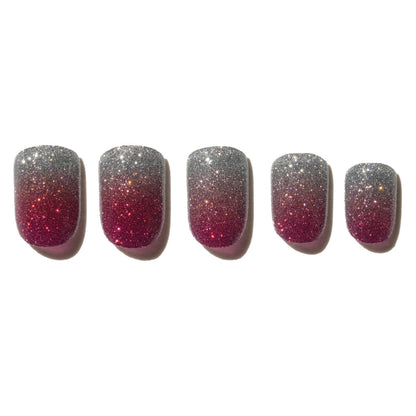 Five glittery pink and silver nails on a white background