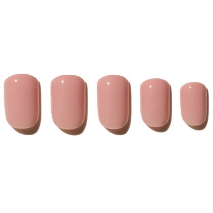 Five pink press on nails on a white background