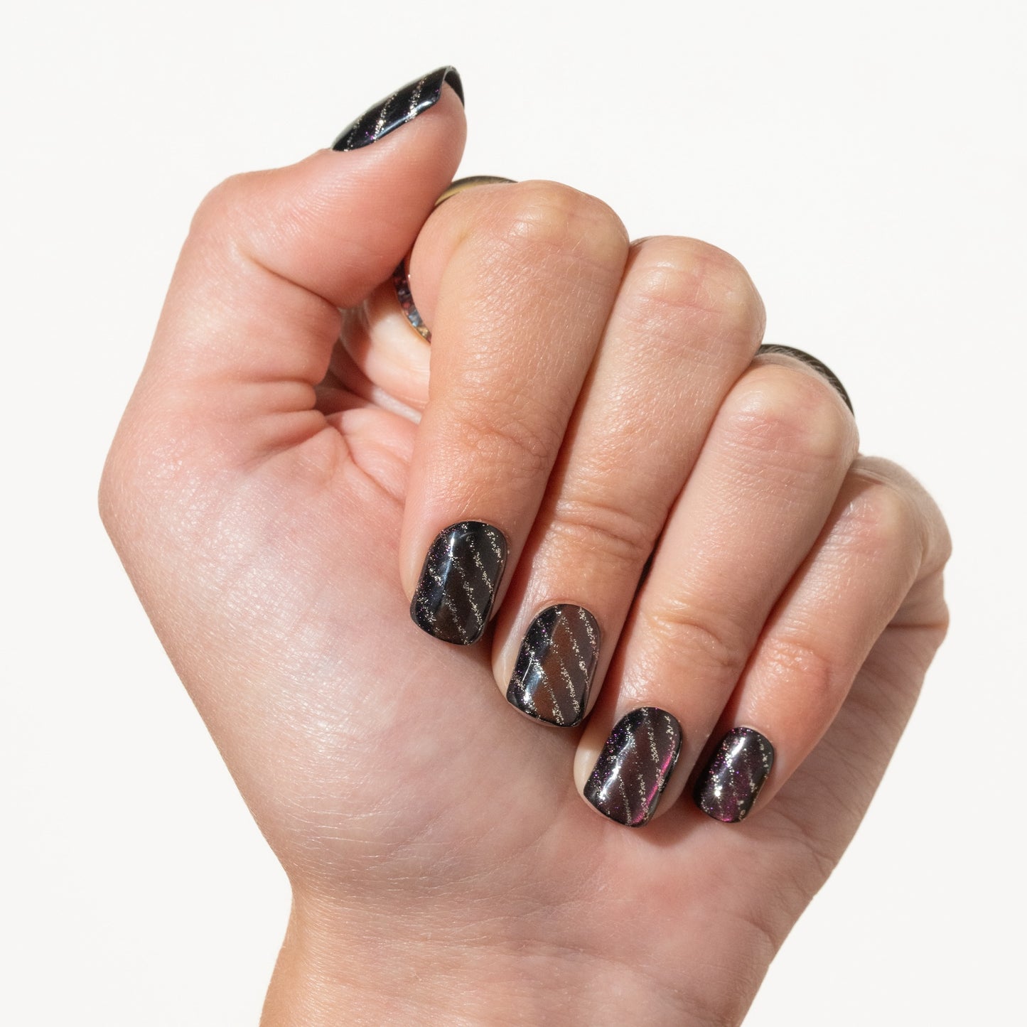 Hand with purple press on nails on a white background