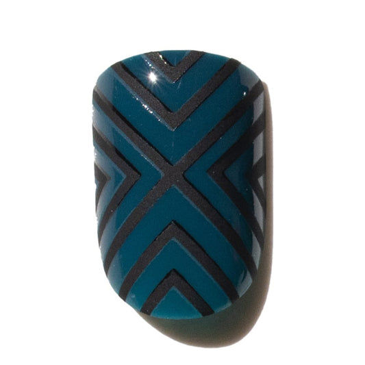 Blue and black patterned press on nail on a white background