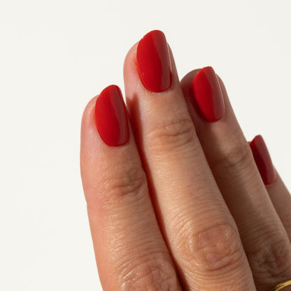 Hand with red press on nails on a white background