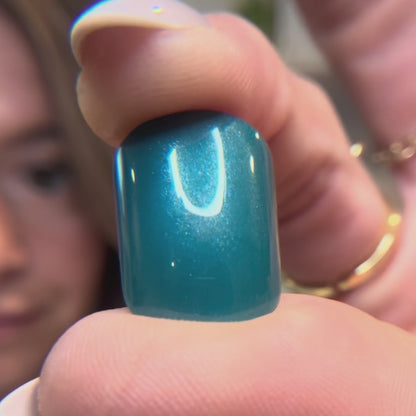 Video showing dark teal press on nail close up